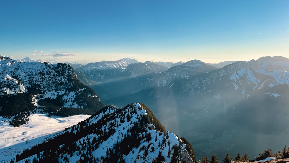 a person standing on top of a snow covered mountain