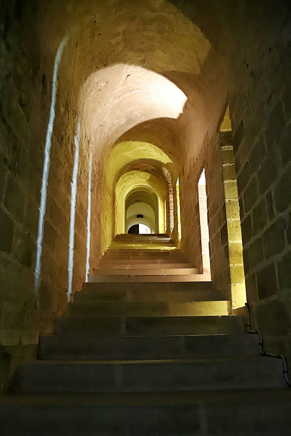 a long tunnel with stairs leading up to it