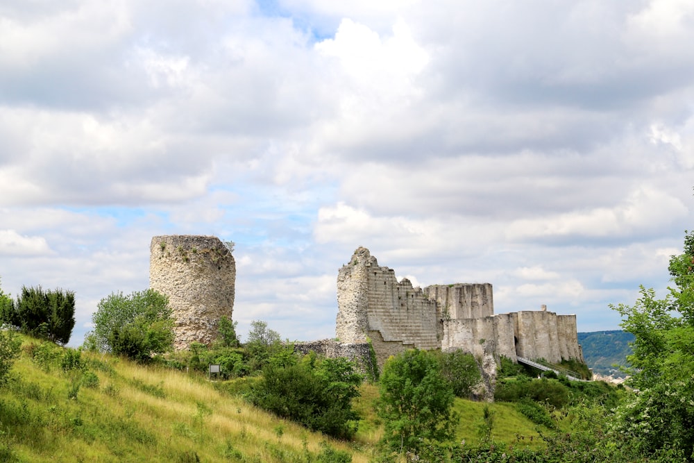 a large castle sitting on top of a lush green hillside