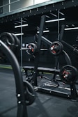 a gym with a row of exercise equipment