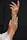 Elegant hand adorned with multiple silver rings against a soft ivory backdrop.