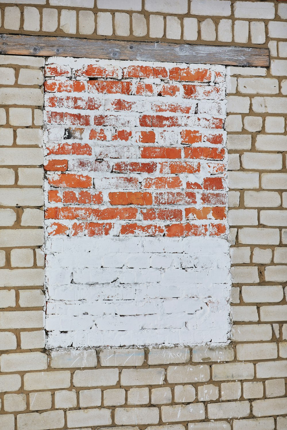 a red and white brick wall with a window