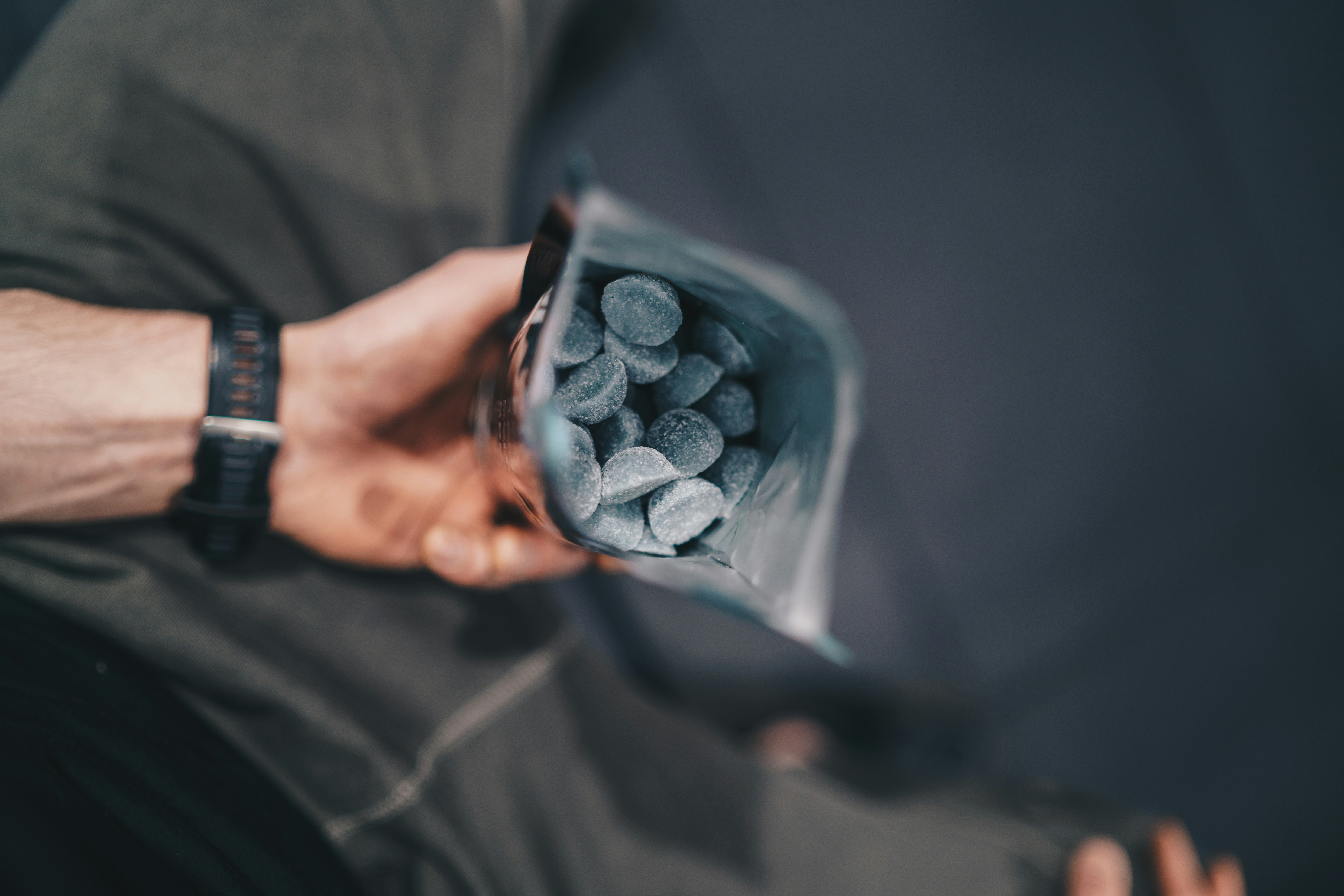 a person holding a bag of dog food