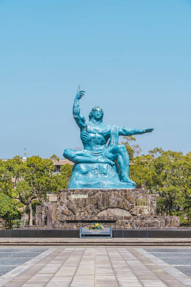 a statue of a man sitting on top of a rock
