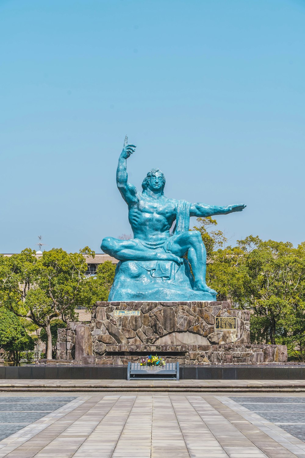 a statue of a man sitting on top of a rock