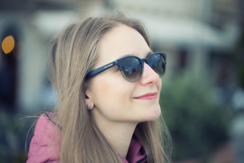 a woman wearing sunglasses looking off into the distance