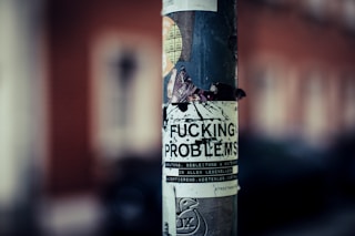 a close up of a sticker on a pole von Markus Spiske (@markusspiske)