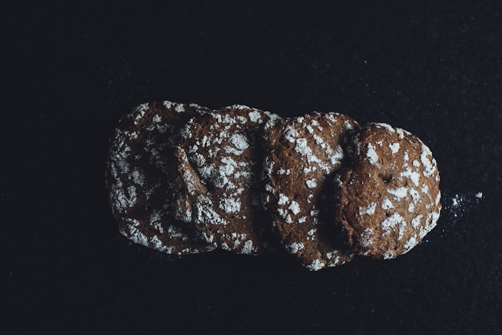 a close up of three cookies on a black surface