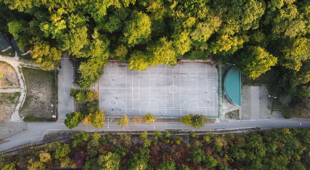 an aerial view of a basketball court surrounded by trees