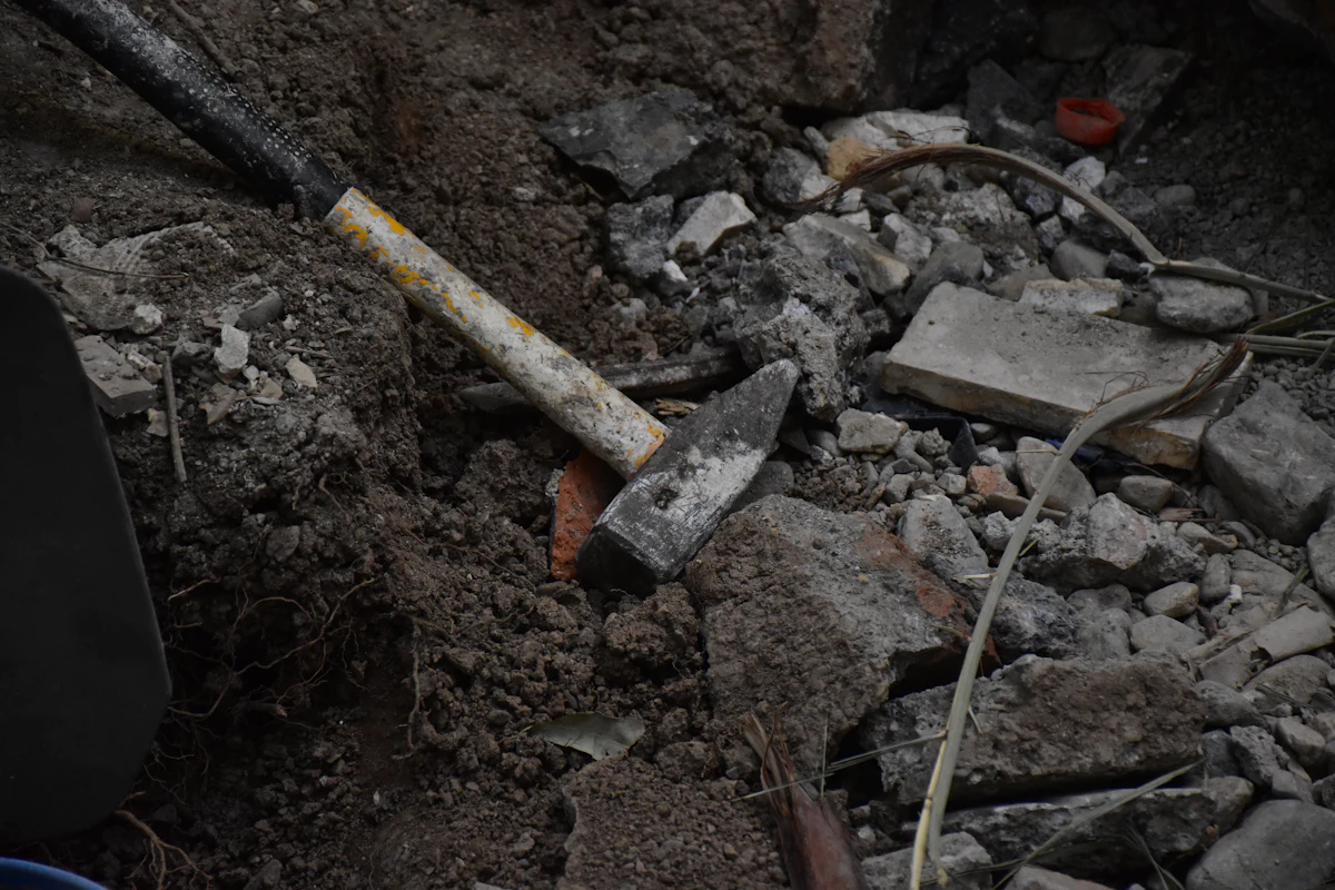 Hammer resting on broken material after dismantling