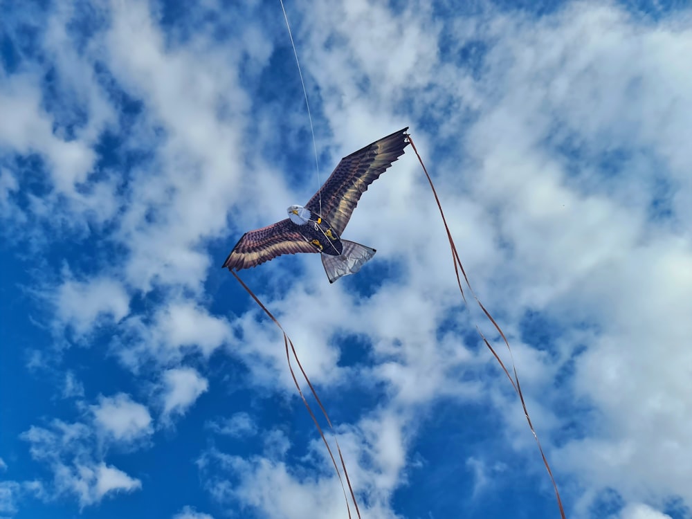a kite flying high in the sky on a cloudy day