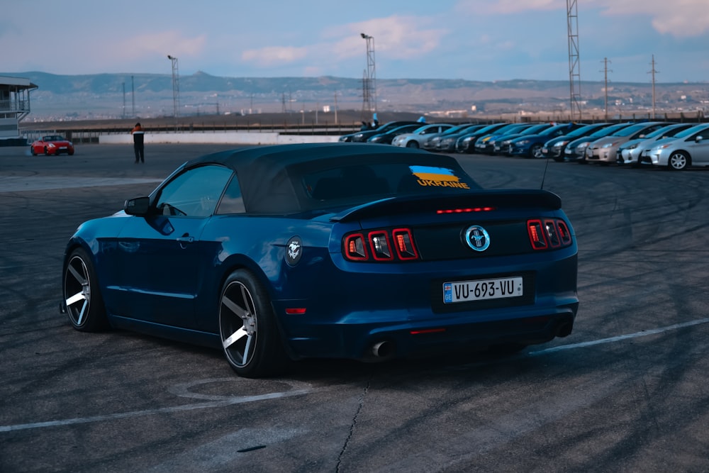 a blue sports car parked in a parking lot