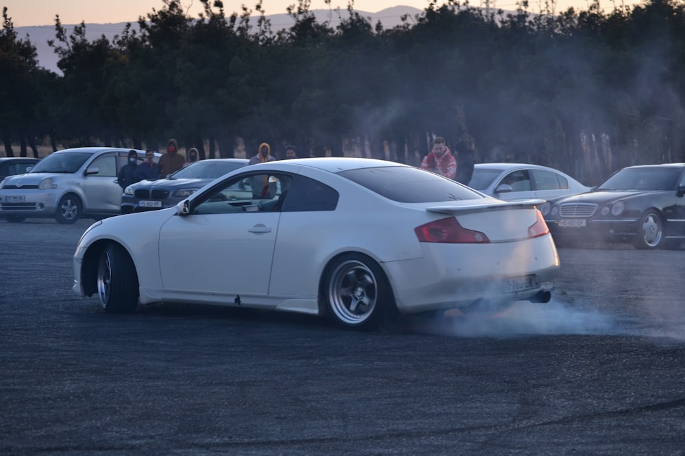 a white car with a lot of smoke coming out of it