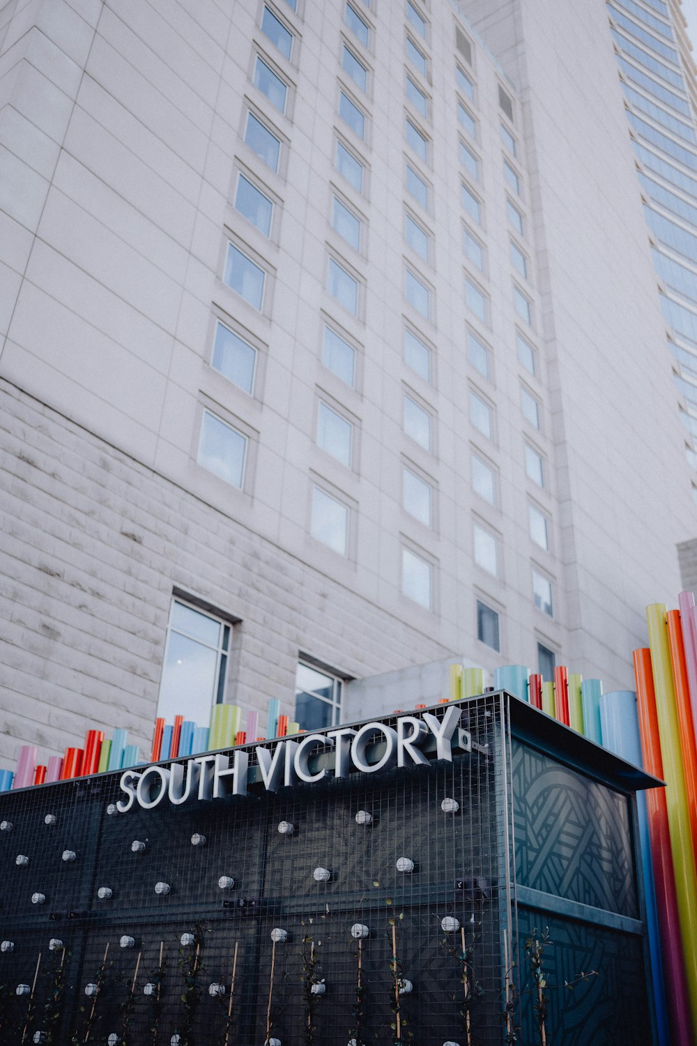 a tall building with a sign that says south victory