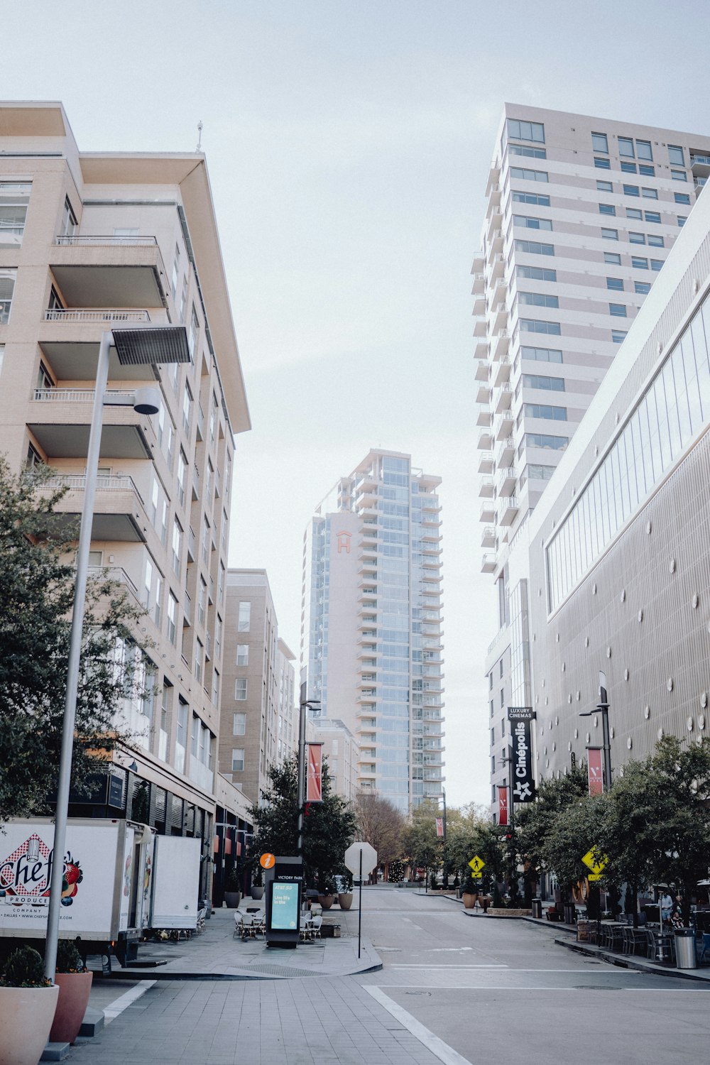 a city street with tall buildings in the background