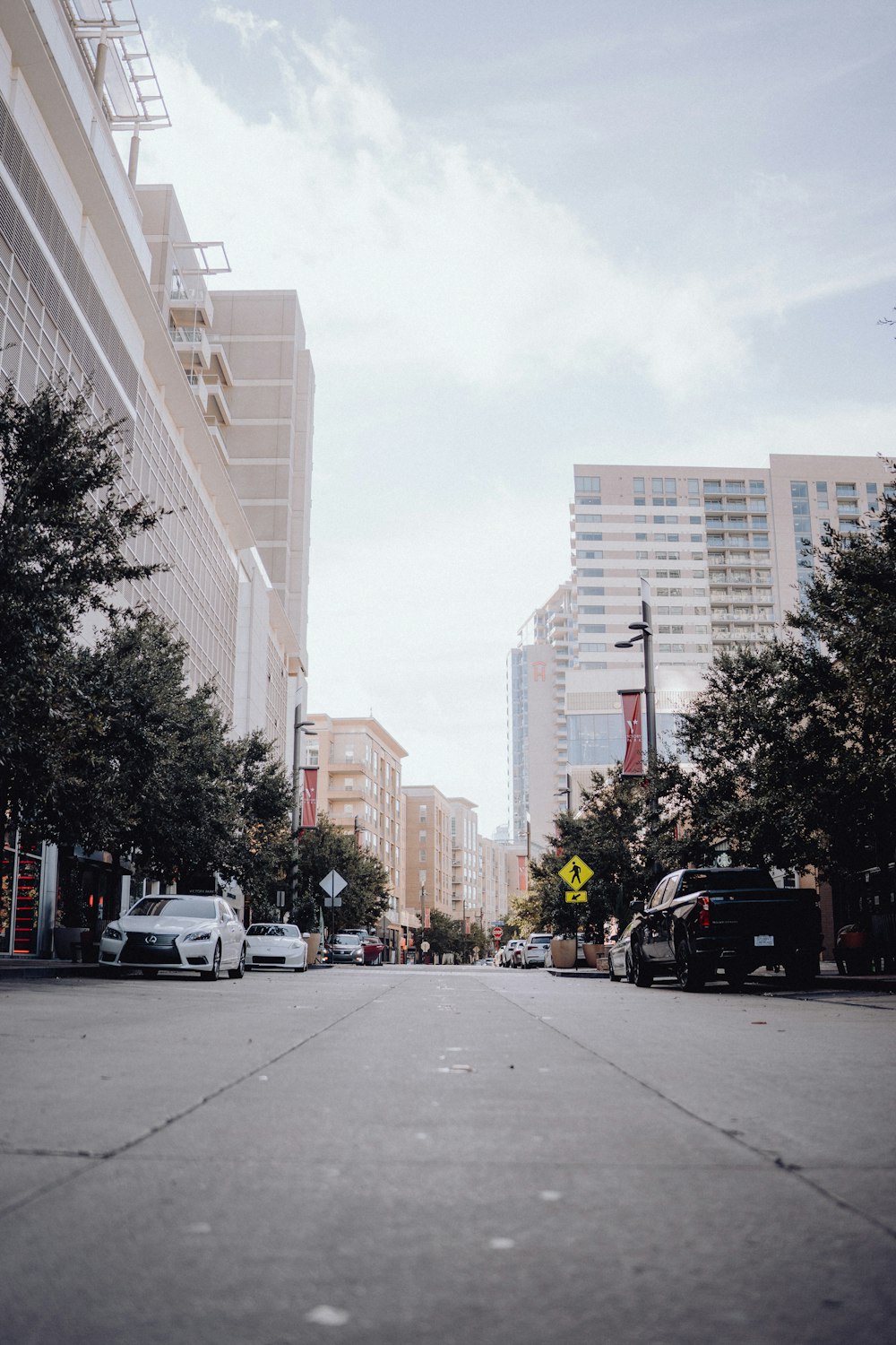 a city street with cars parked on both sides