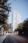 a tall white building sitting next to a street