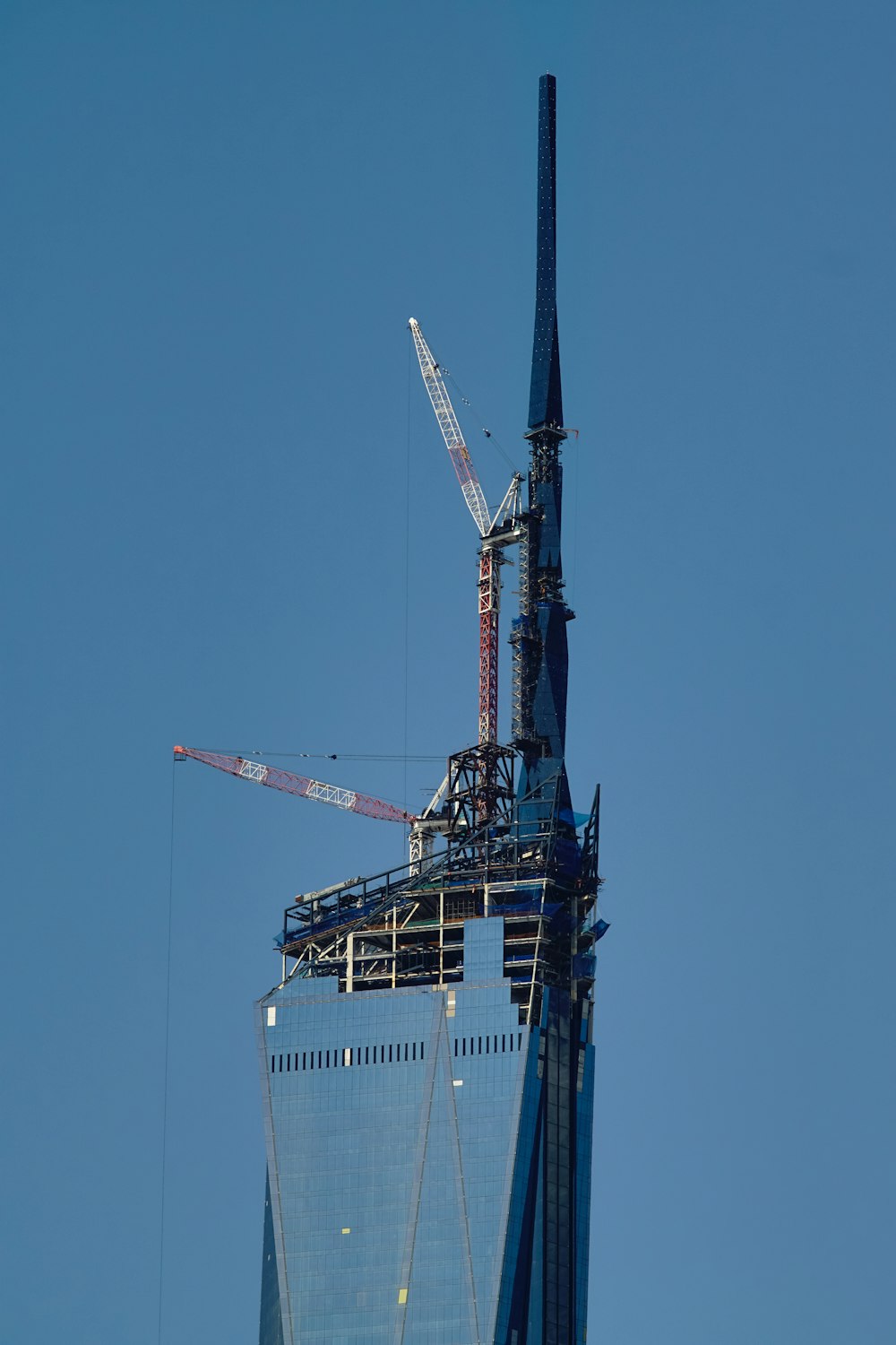 a tall building with a crane on top of it