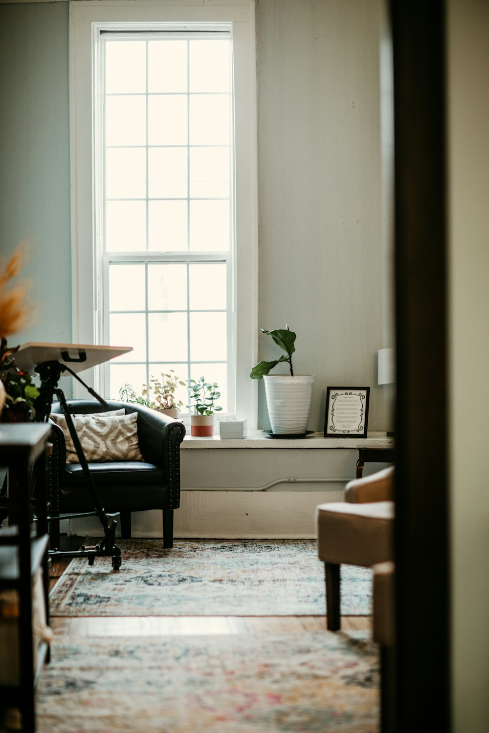 a living room with a chair and a window