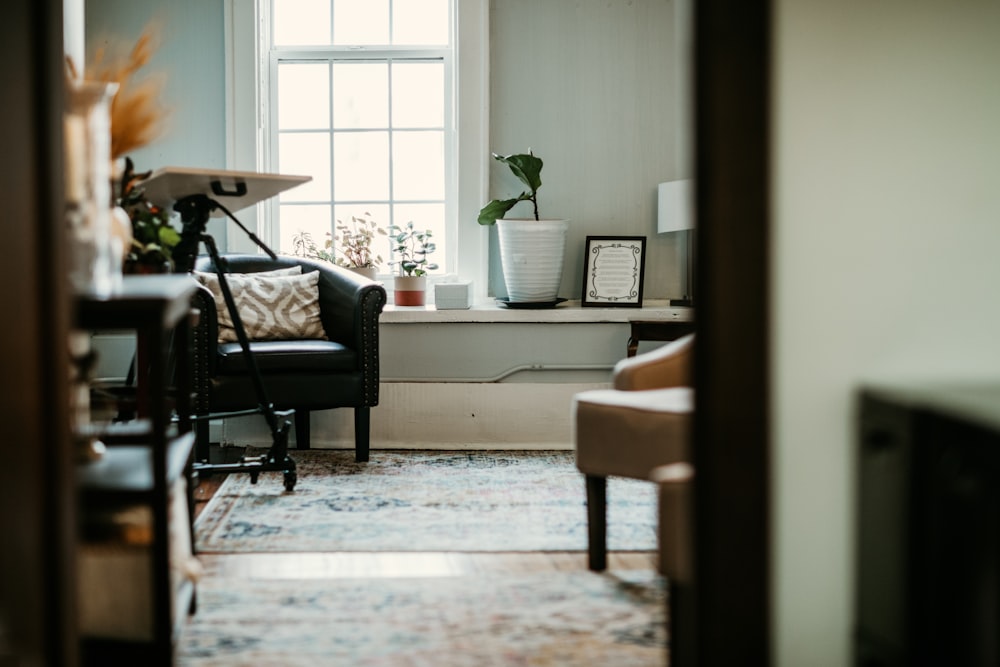 a living room with a chair and a window