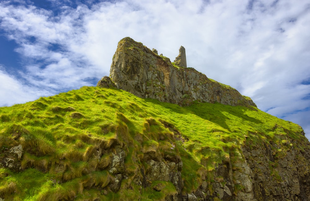 a grassy hill with a castle on top of it