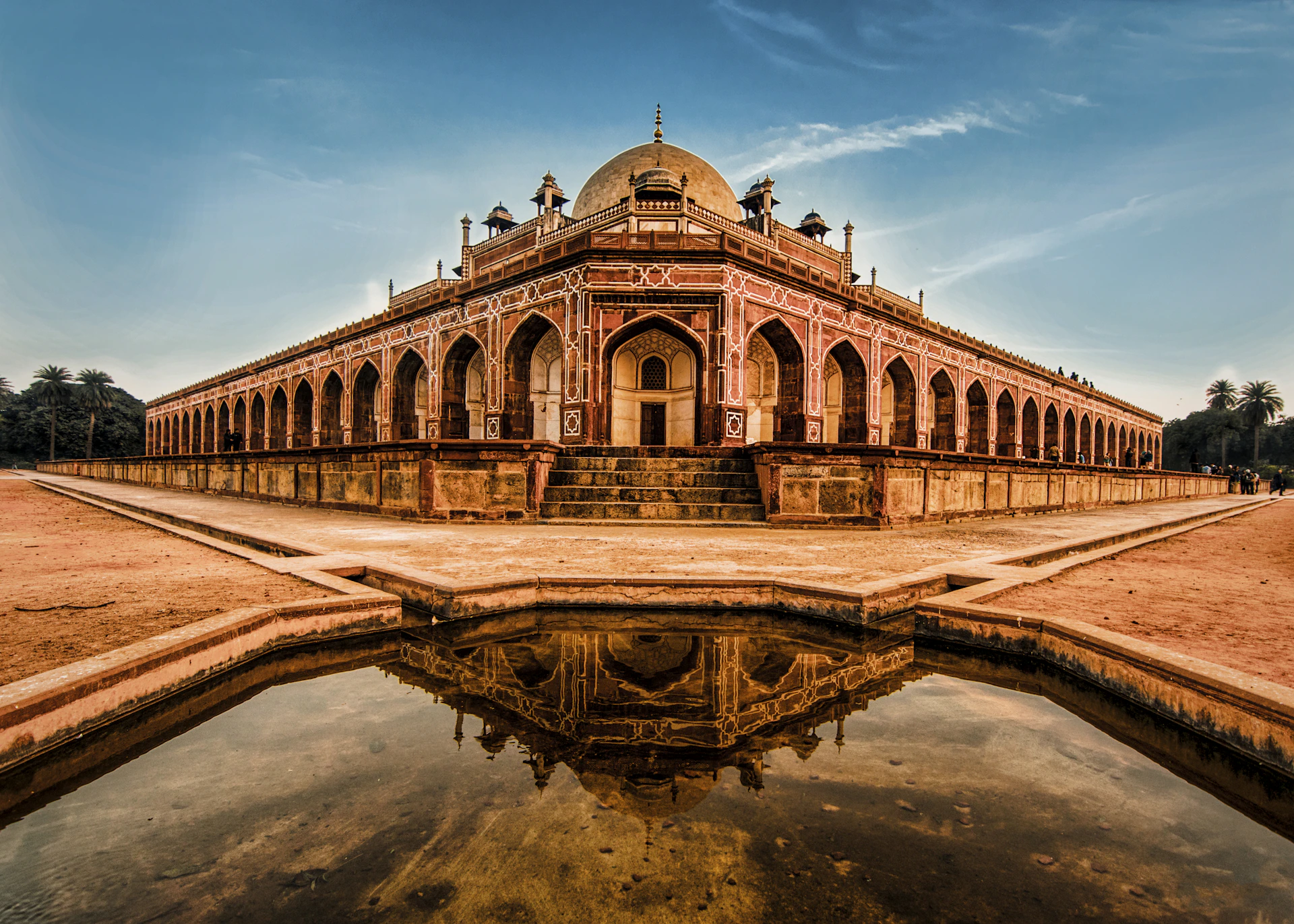 a building with a pond in front of it