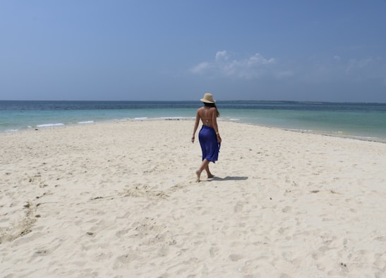 a person walking on a beach near the ocean