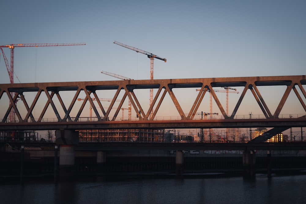 a bridge that has some cranes on top of it