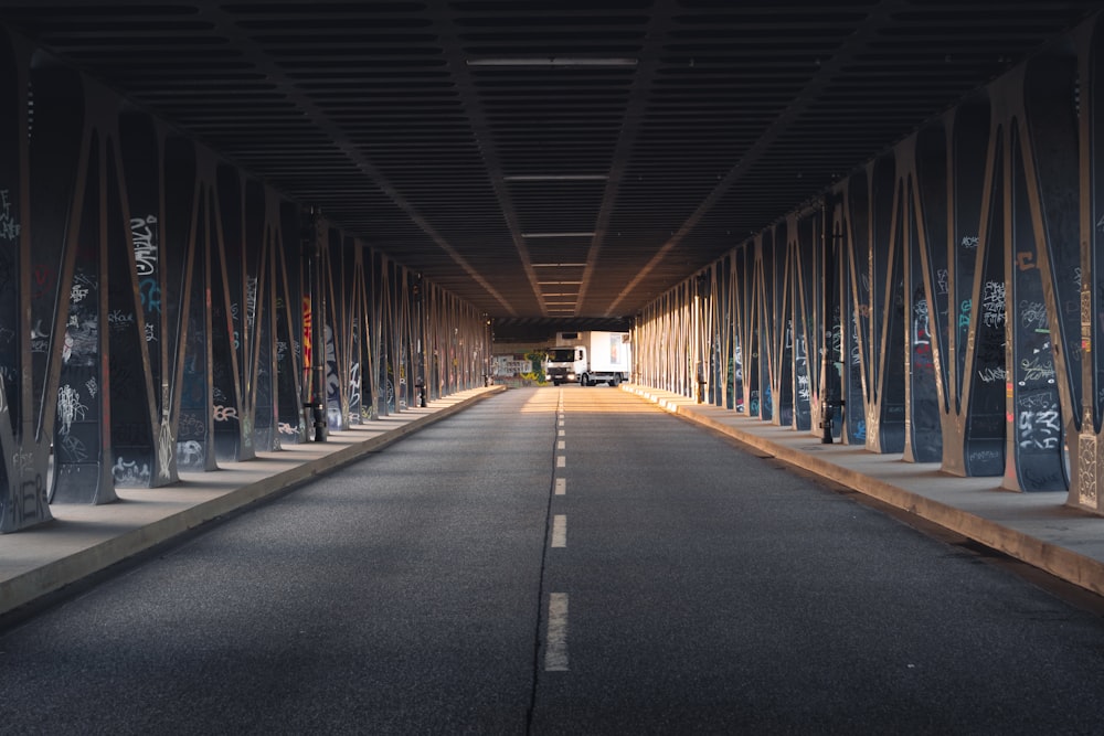 an empty street with a long row of poles