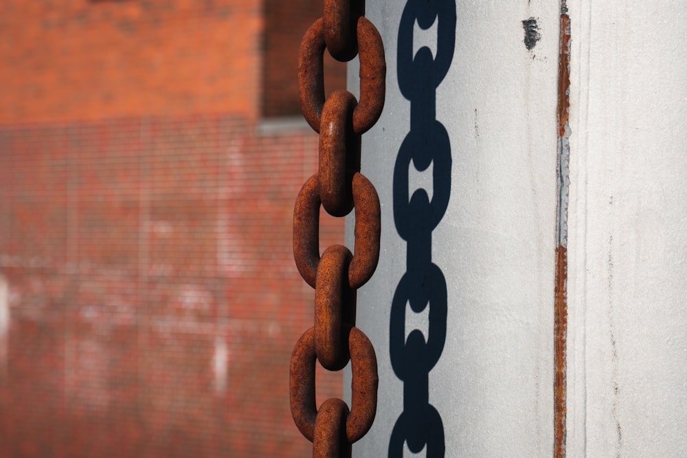 a rusted chain is hanging on a pole