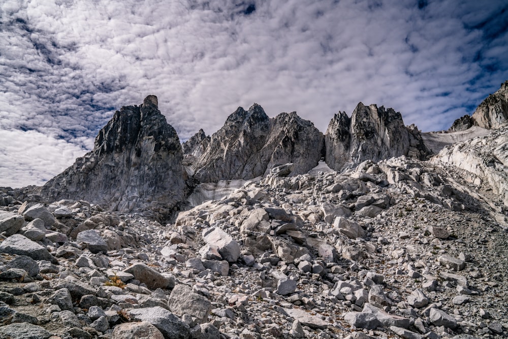 a rocky area with rocks and boulders under a cloudy sky