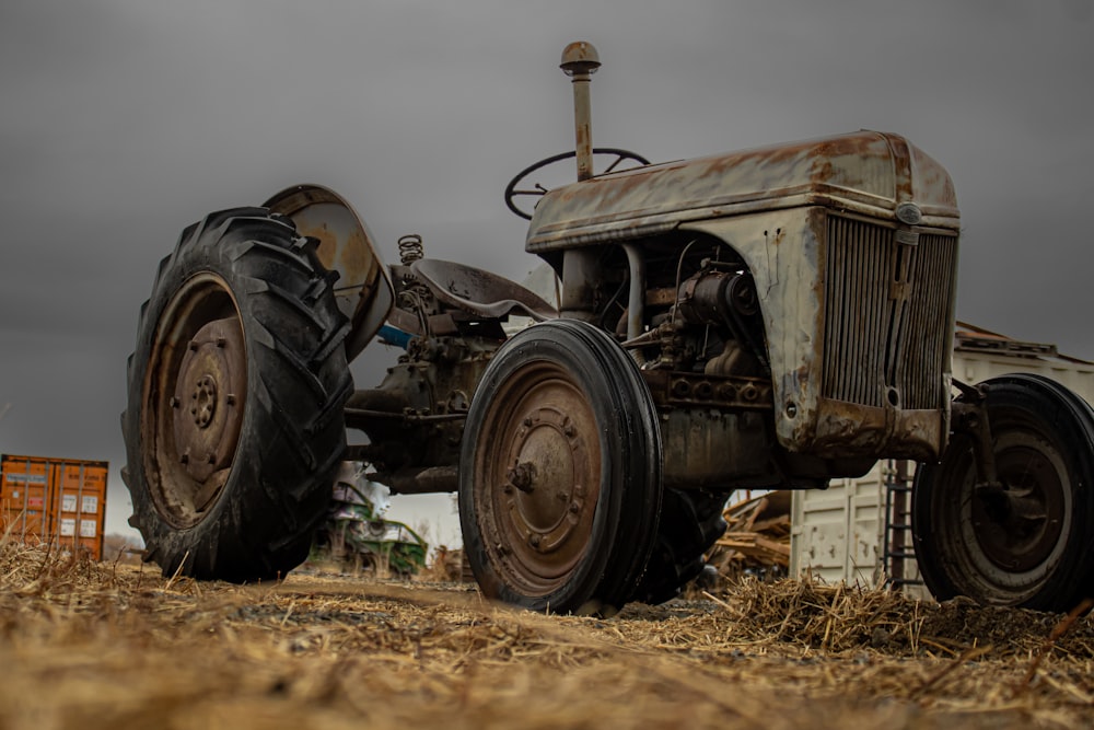 an old tractor sitting in the middle of a field