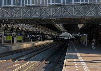 a train station with a train on the tracks