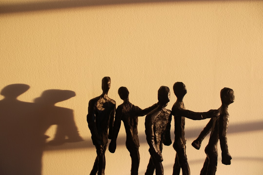 a shadow of a group of people holding hands,
