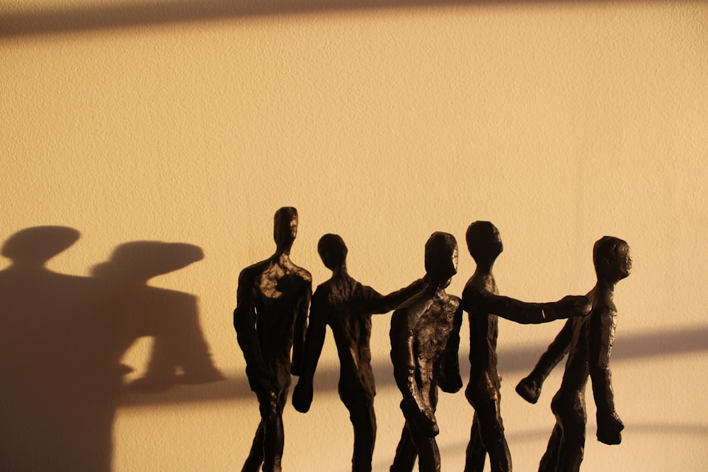 a shadow of a group of people holding hands