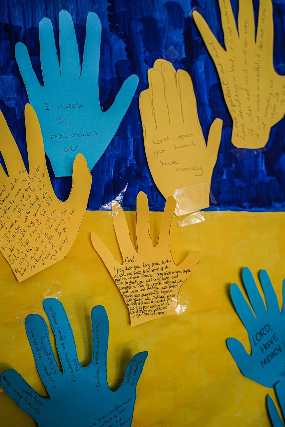 a group of handprints on a yellow and blue background