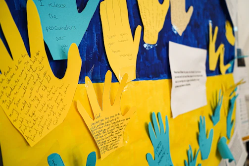 a bulletin board with handprints and writing on it