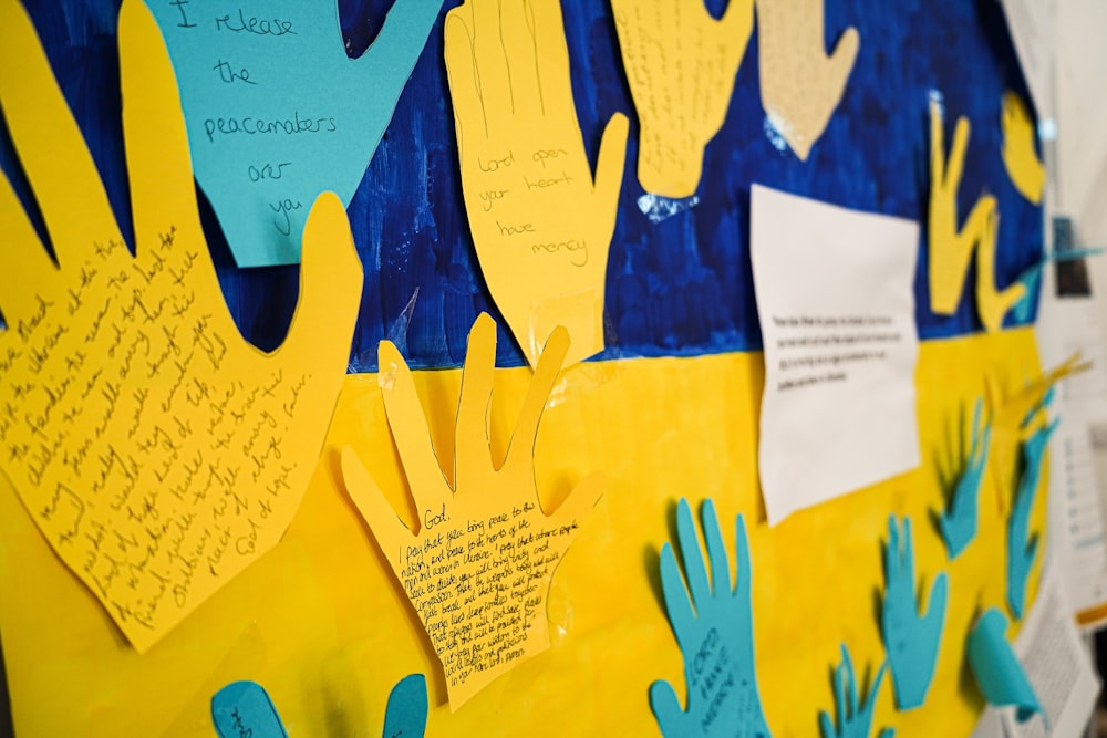 a bulletin board with handprints and writing on it