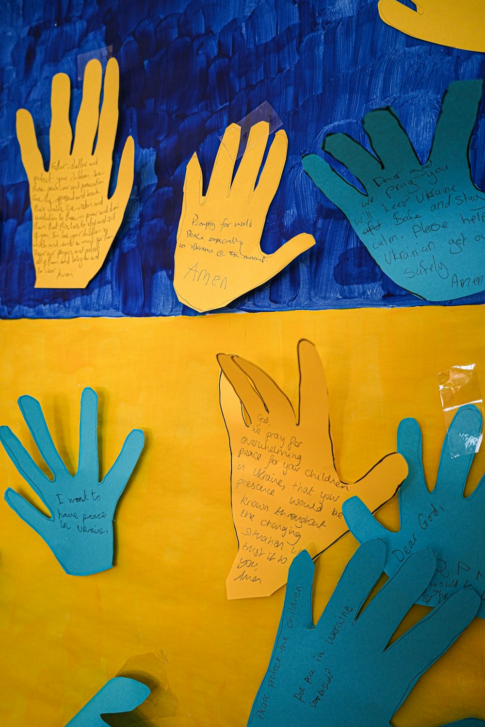 a group of handprints on a yellow and blue background