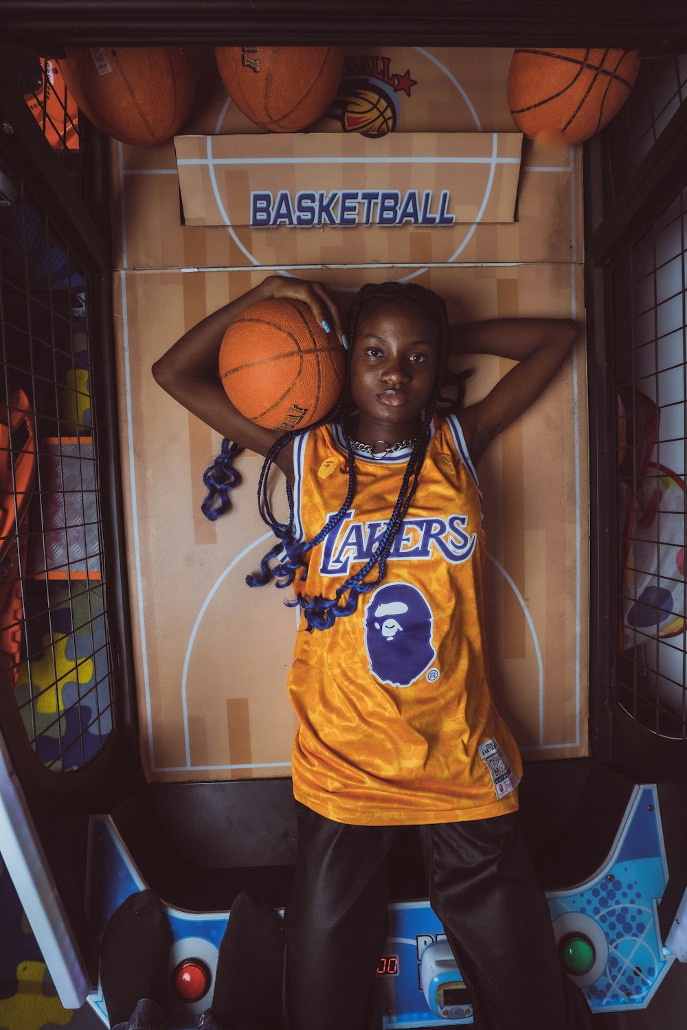 a young girl in a basketball uniform posing for a picture