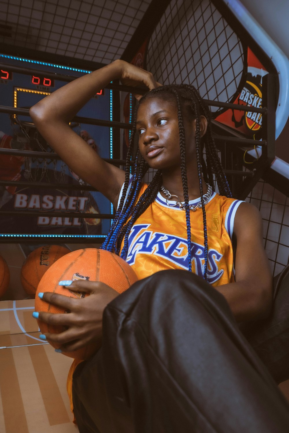 a woman sitting in a chair holding a basketball