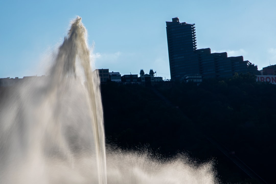 a large water fountain spewing water into the air,