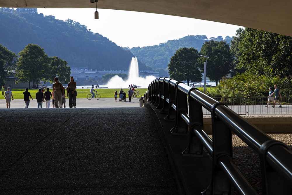 a group of people walking under a bridge