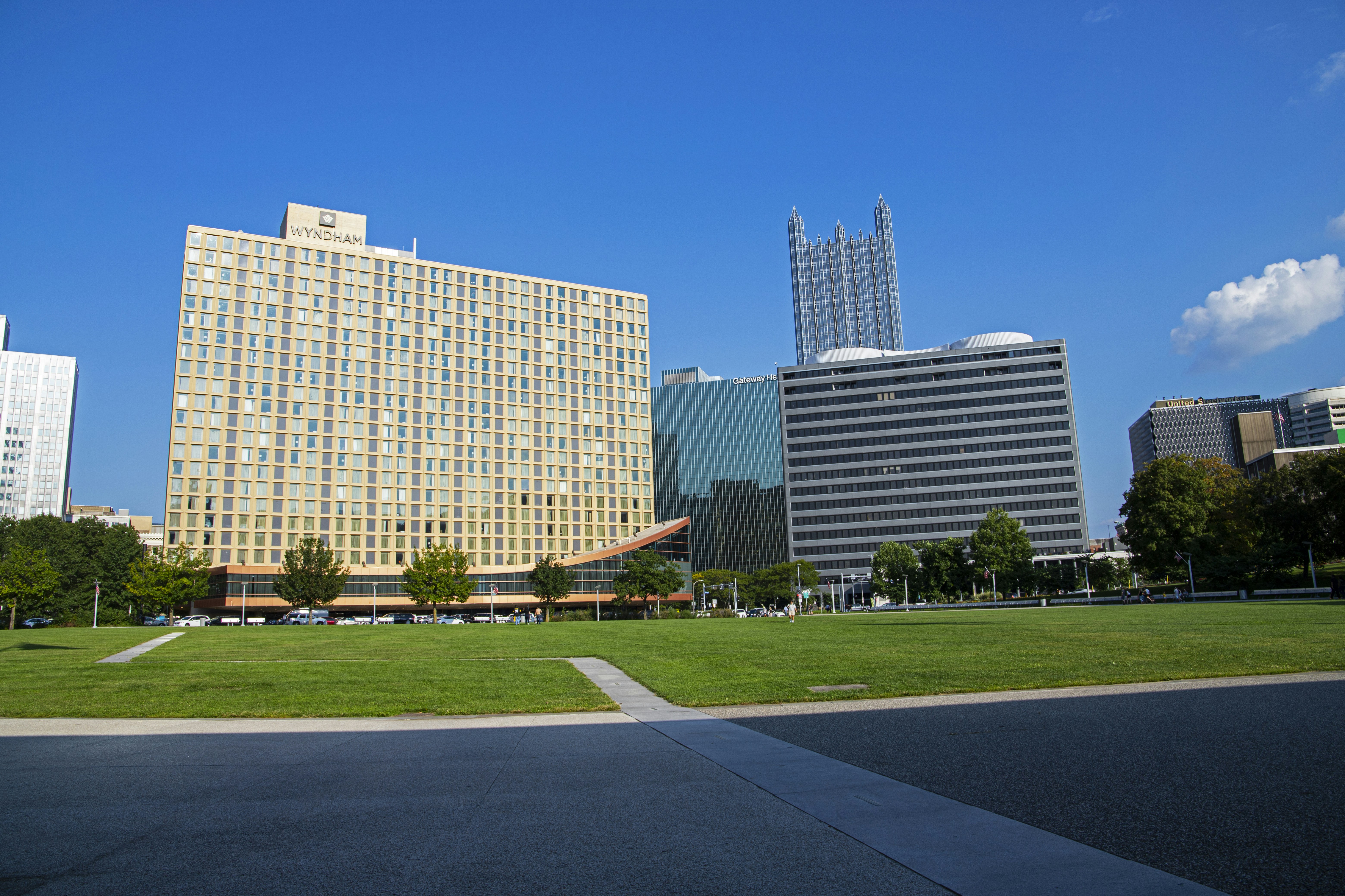 a grassy field in front of a large building