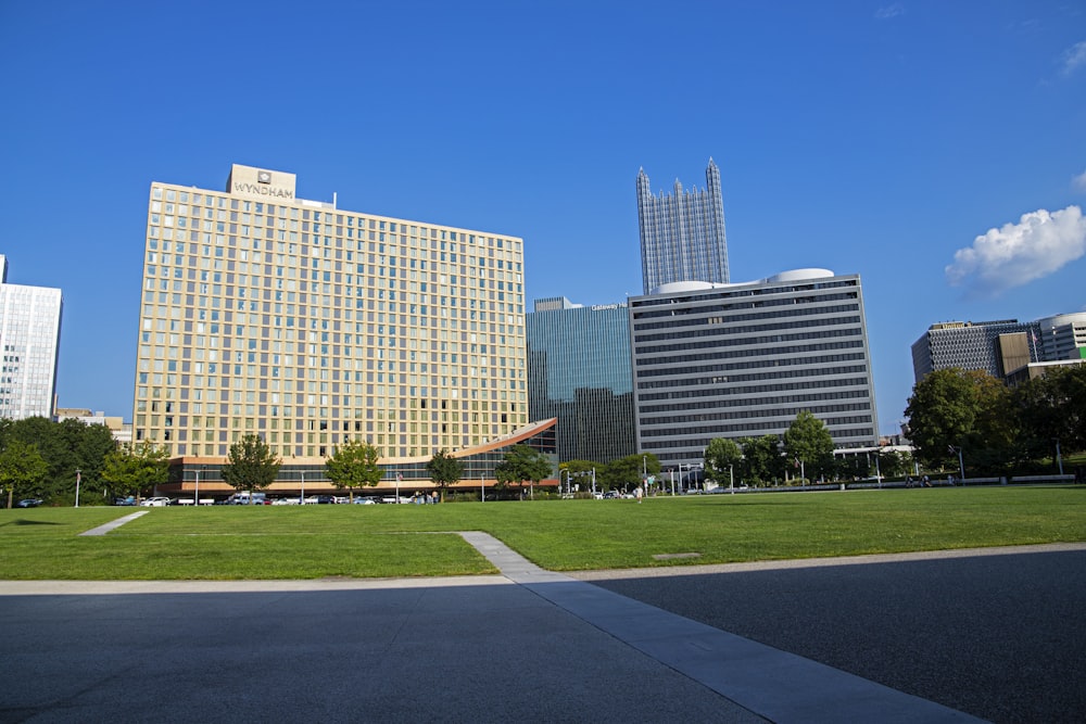 a grassy field in front of a large building