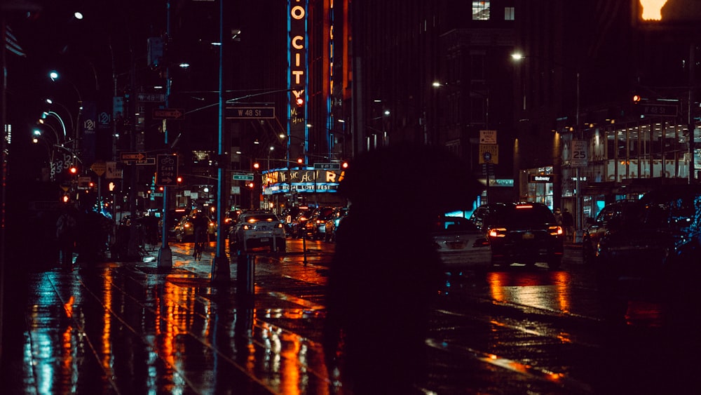 a city street filled with lots of traffic at night