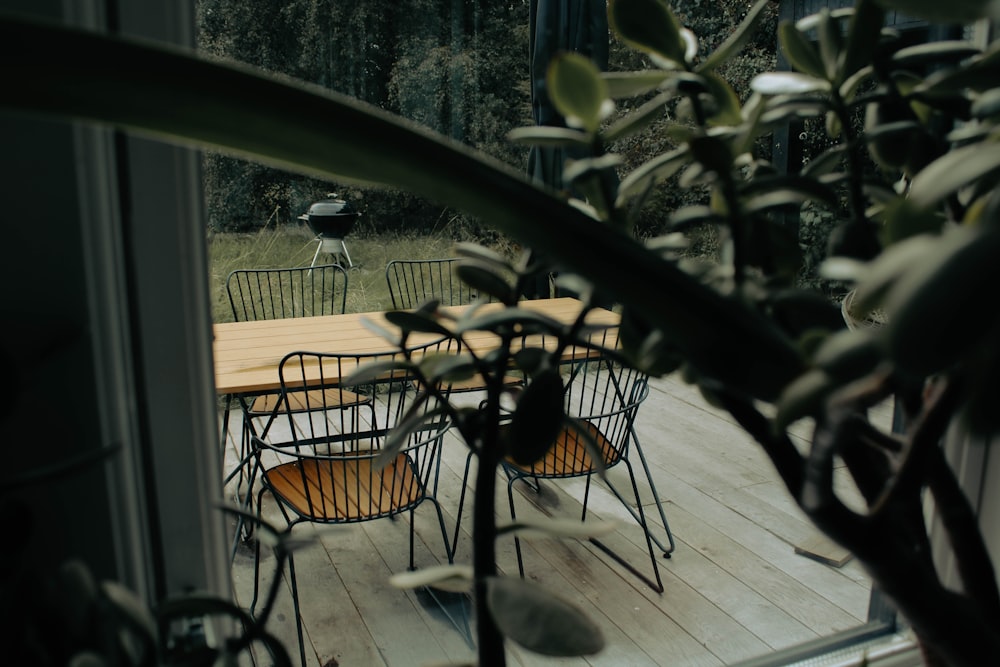 a table and chairs on a wooden deck