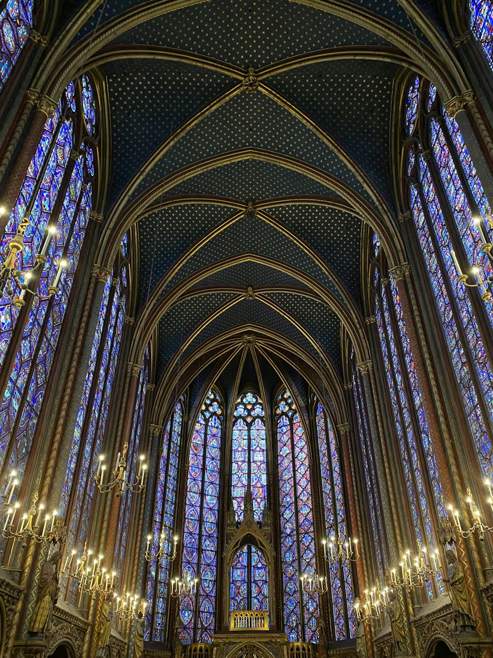 a large cathedral with stained glass windows and chandeliers
