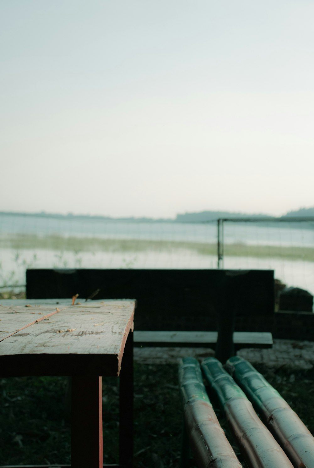 a couple of benches sitting next to a body of water