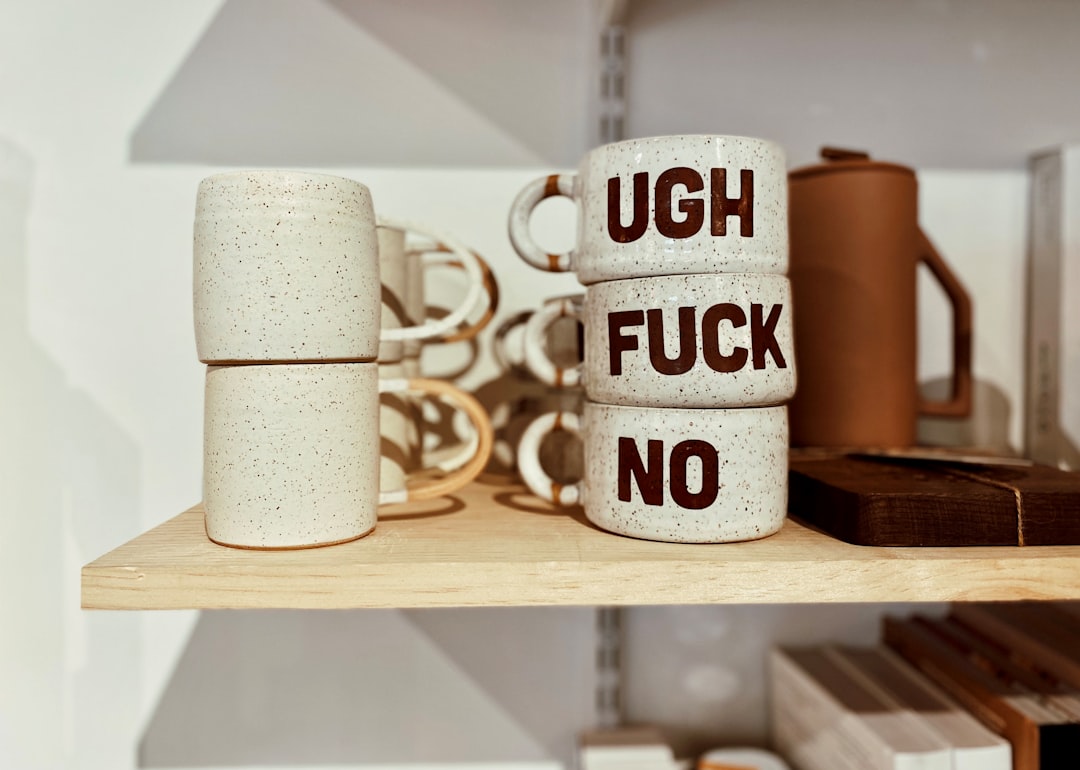 a couple of mugs that are on a shelf